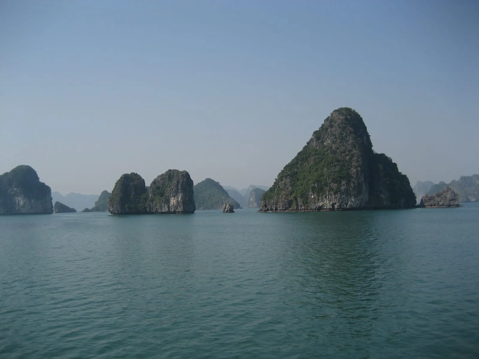 Tall limestone islands rising from calm water